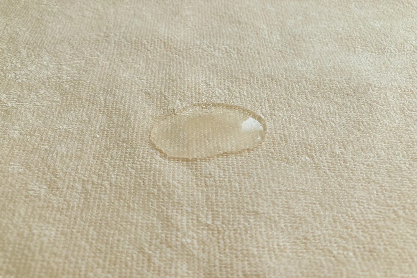 防水シーツの表面で水をはじいている様子